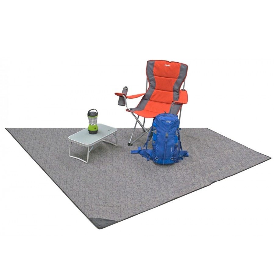 Three-quarter view of the Vango Universal Carpet 180 x 280 - CP010 shown with camping chair, table and rucksack.