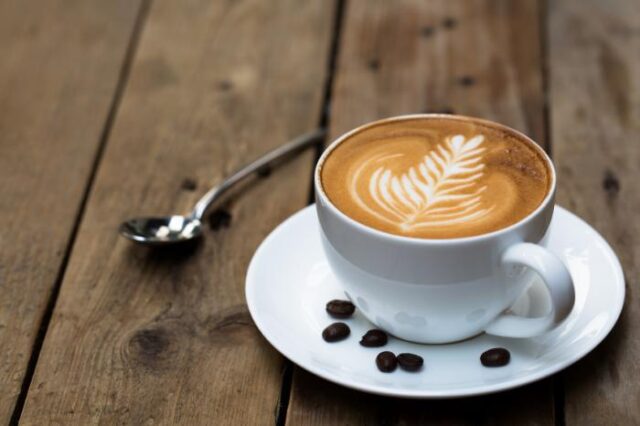 A latte with a tree pattern in the foam